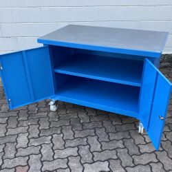 work-bench with wheels and shelf inside a two-door cabinet